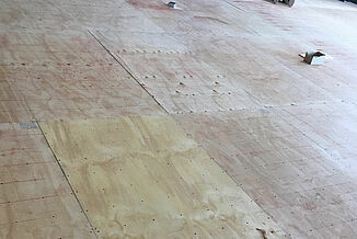 College of the Holy Cross - REGUPOL soundpanel Angled view of the installation process at REGUPOL acoustics are added to the flooring in the recreation and wellness facility in the College of the Holy Cross.