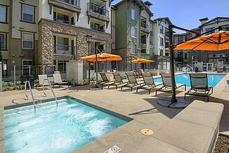 View of the pool area at Avalon Bay Communities in Glendora. The area features a hot tub and swimming pool for residents.