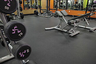 Anytime Fitness - Weight Rack and Equipment Anytime Fitness facility featuring REGUPOL sonusfit m520 flooring, as well as a variety of weight training equipment throughout the space.
